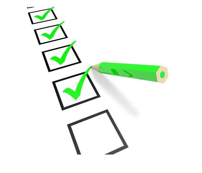 checklist with check boxes and green pen